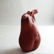 Blown glass sculpture resembling a woman's body.