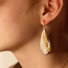 Homemade earrings on a person.