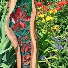 Stained glass mirror standing in a flower field.